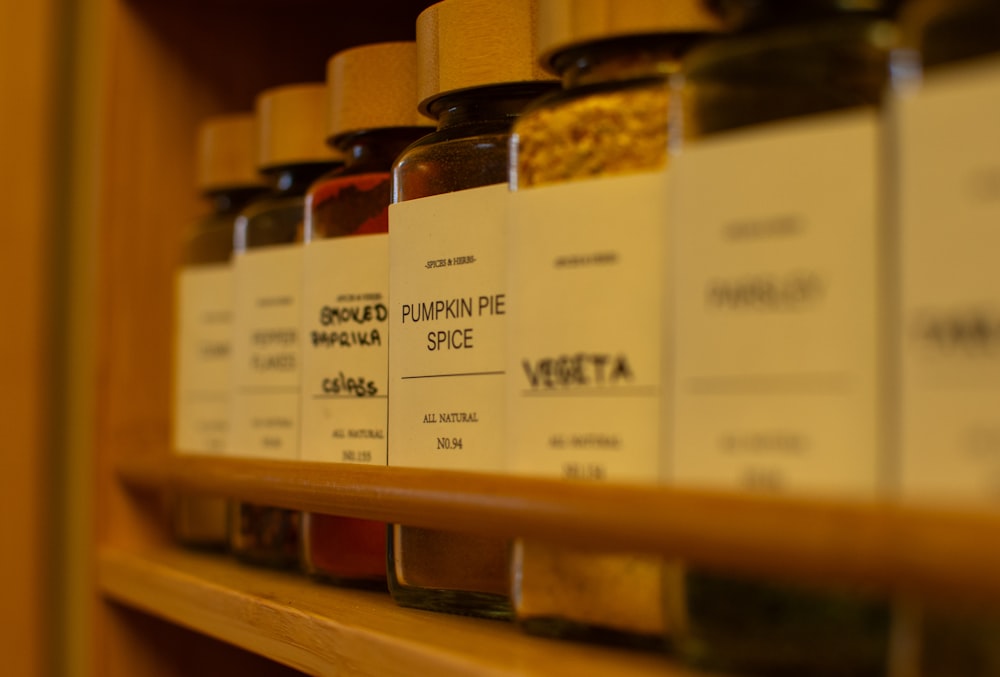 a shelf filled with lots of different types of spices