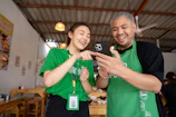 A smiling restaurant owner checking their restored online listing on a tablet