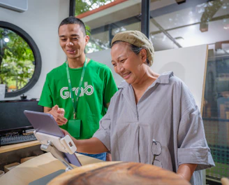 Photo of a friendly technician assisting a customer with internet service setup, with accents of fluorescent green and black.