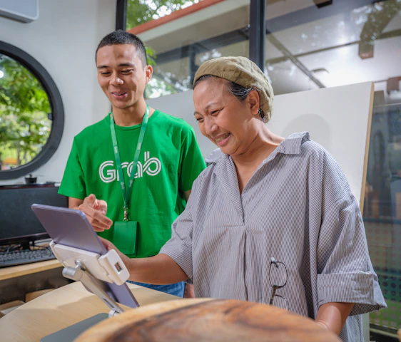Photo of a friendly technician assisting a customer with internet service setup, with accents of fluorescent green and black.