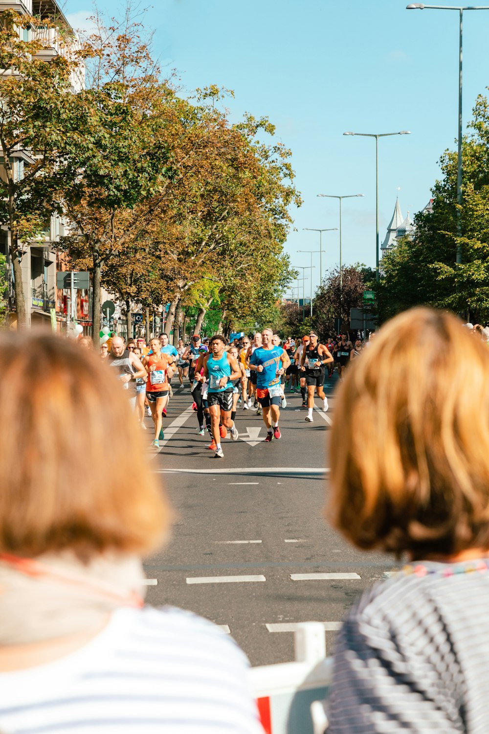 a group of people running down a street