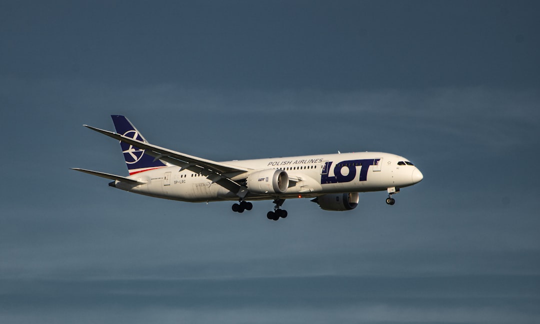 a large jetliner flying through a blue sky,