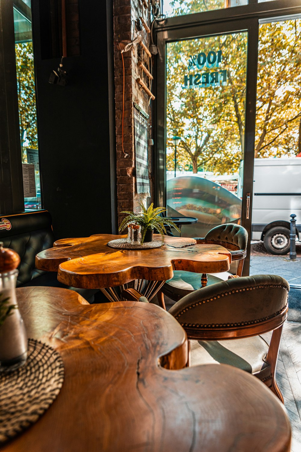 a restaurant with a wooden table and chairs