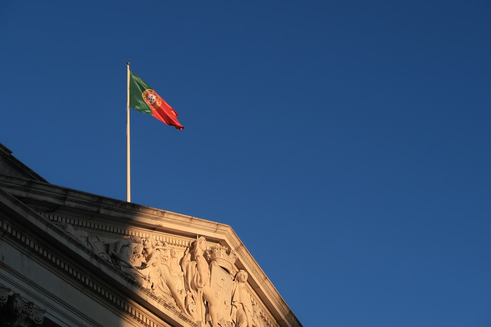 a flag is flying on top of a building