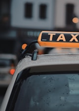 A close-up of a credit card being used to pay for a taxi ride inside a car.