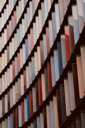 A modern geometric pattern overlaying a law book and scales of justice.