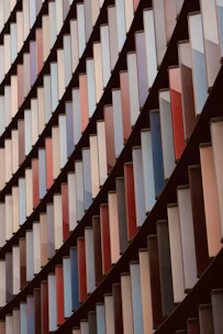 A modern geometric pattern overlaying a law book and scales of justice.