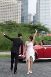 The bride and groom stepping into the modern electric taxi after the ceremony, smiling.