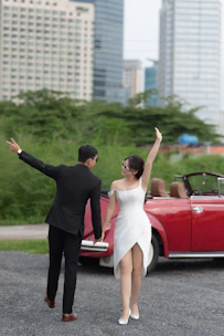 The bride and groom stepping into the modern electric taxi after the ceremony, smiling.