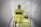 Two bottles of Aramis fragrance are displayed on a reflective surface. The larger bottle on the left contains a yellow liquid and has a golden cap, while the smaller bottle on the right is partially open. Both bottles feature the Aramis label prominently.