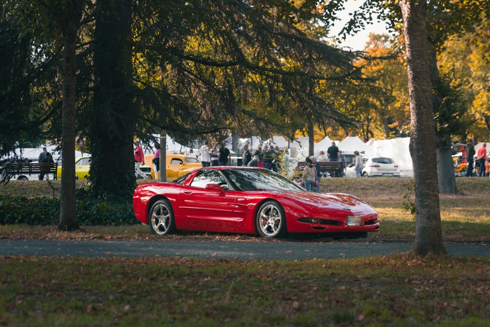 a red sports car parked on the side of a road