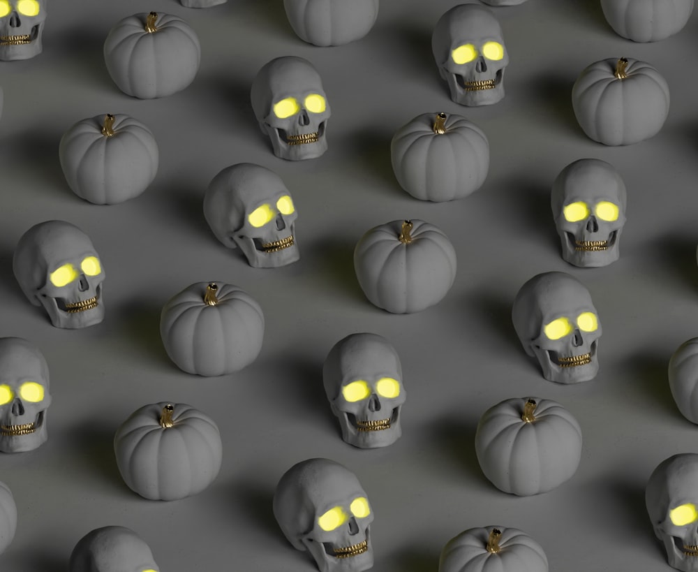 a group of pumpkins with glowing yellow eyes