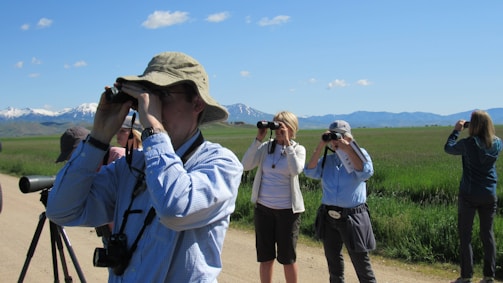 A group of bird enthusiasts observing birds in a natural park.