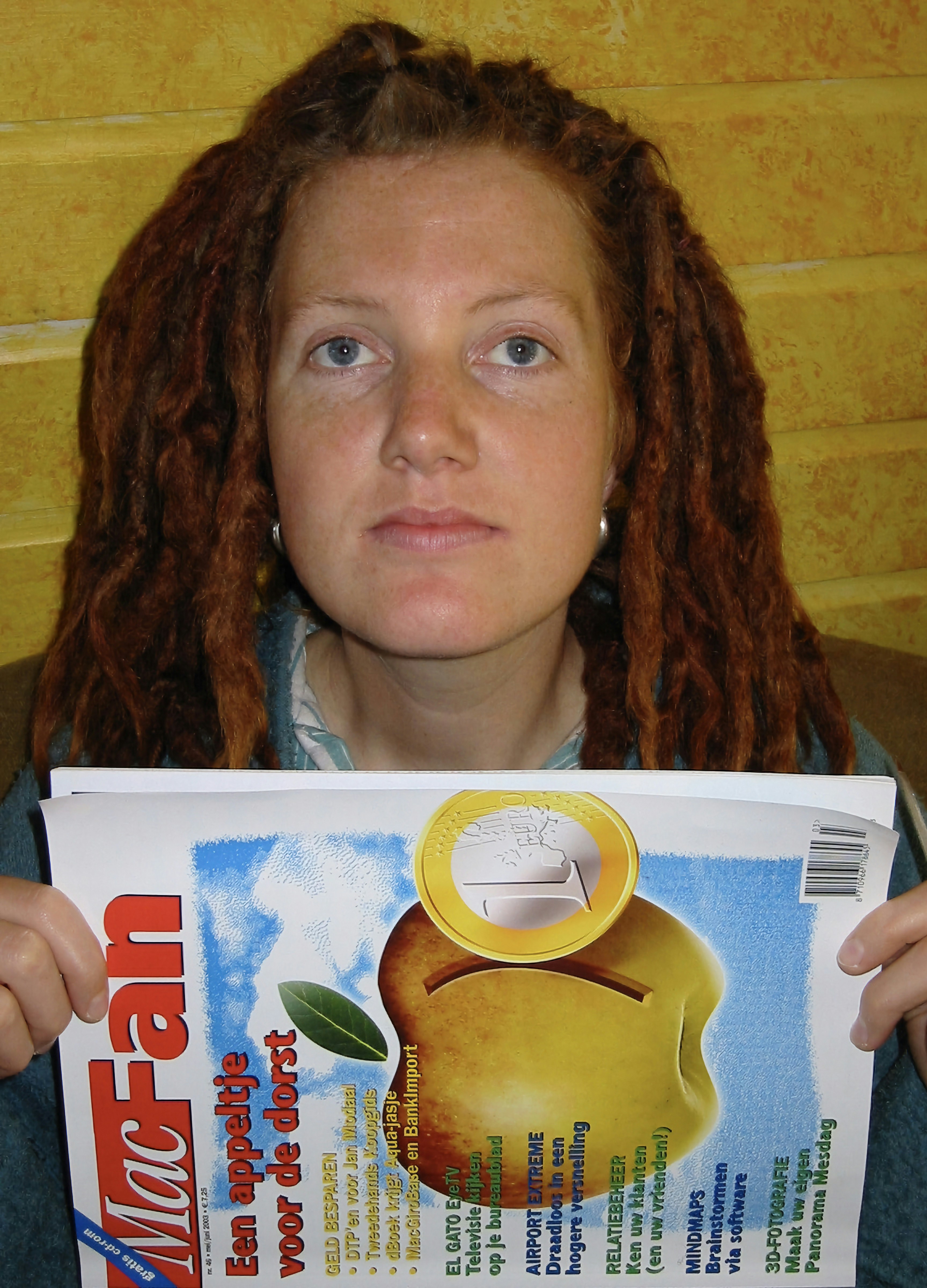 Female music icon with styled dreadlocks in dark editorial setting, dramatic shadow, dim moody atmospheric lighting