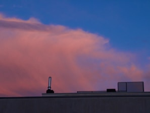 Evening shot of a rooftop with newly installed flashing and clean edges against the city skyline