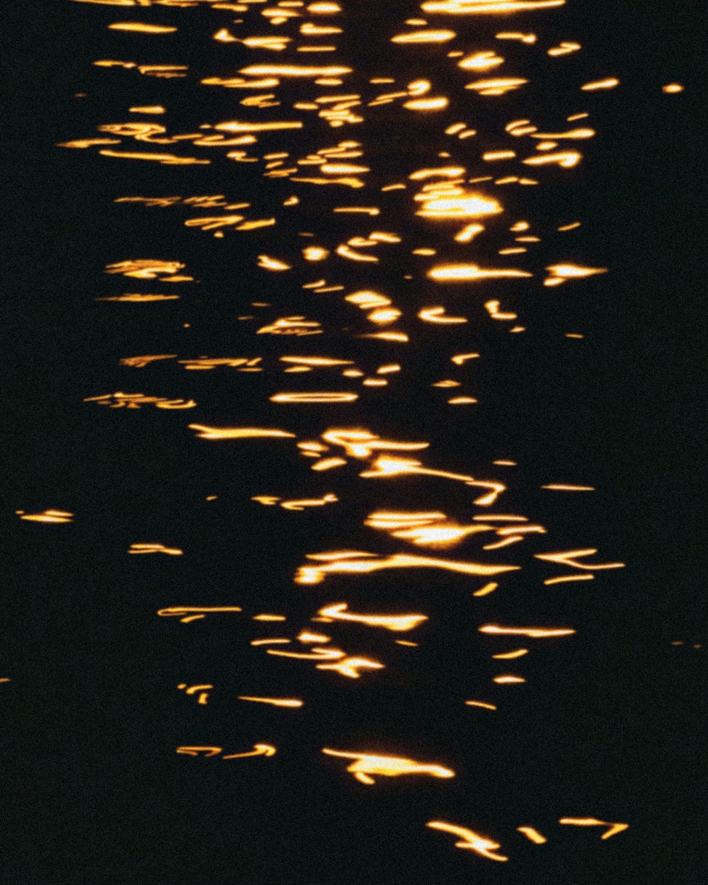 the reflection of a boat on the water at night