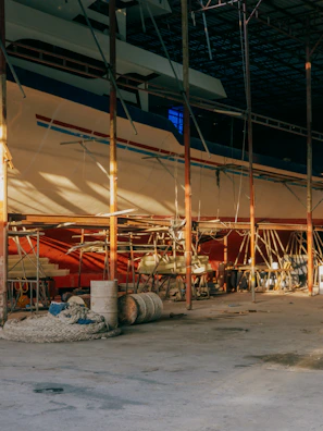 Workers welding and repairing sections of a ship’s structure inside the drydock.