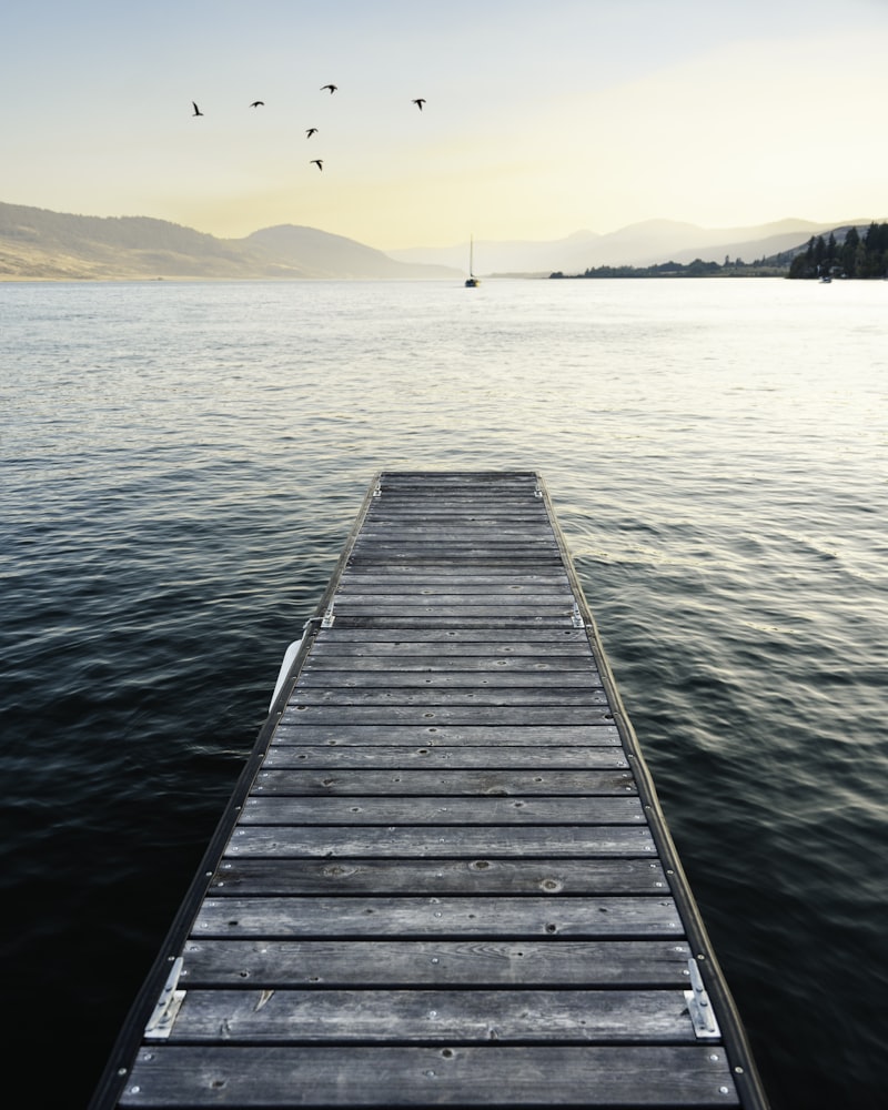 Wooden boat dock on calm lake - Lake Norman dock permits guide