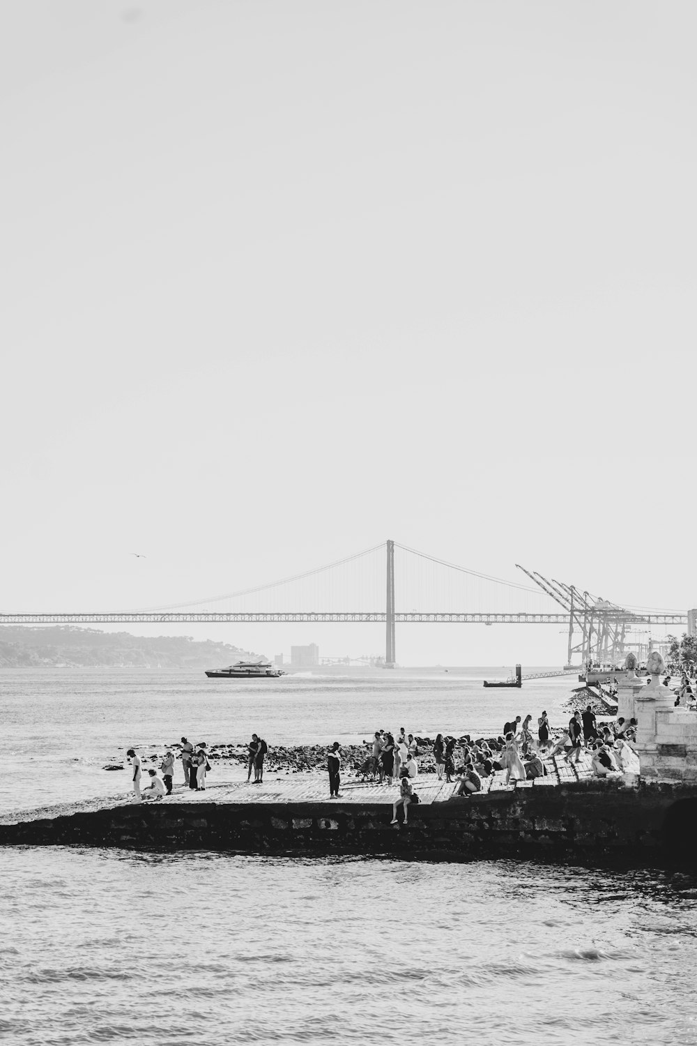 a black and white photo of people on a beach