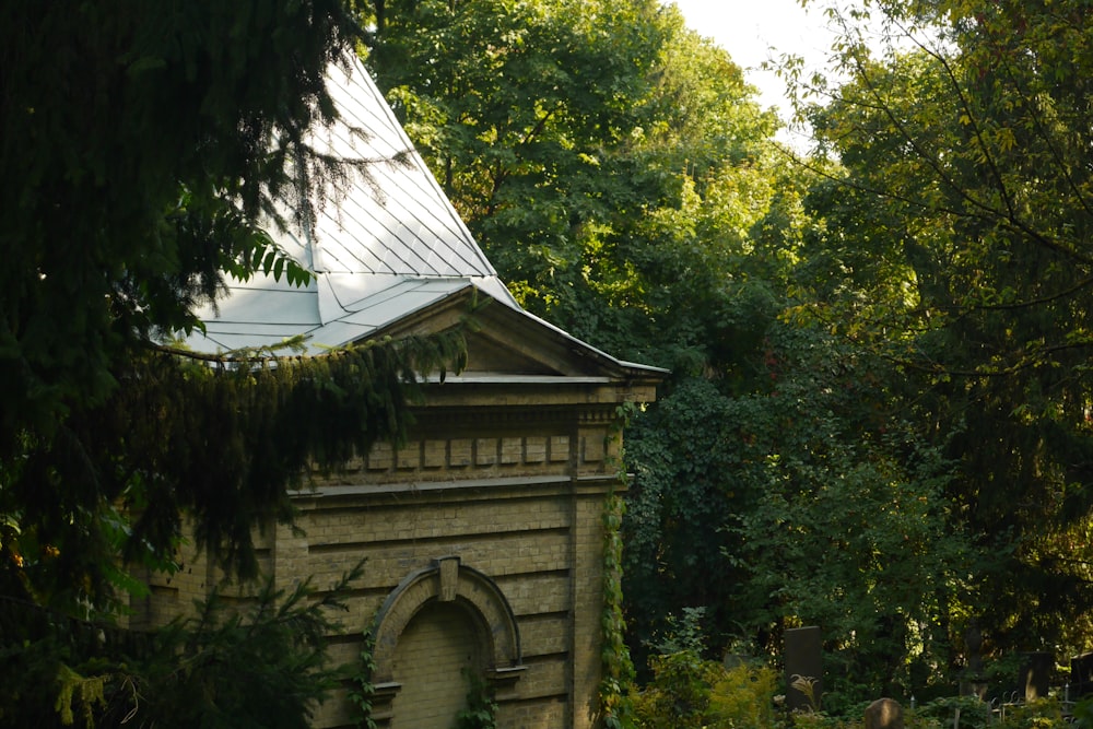 a small tower in the middle of a forest