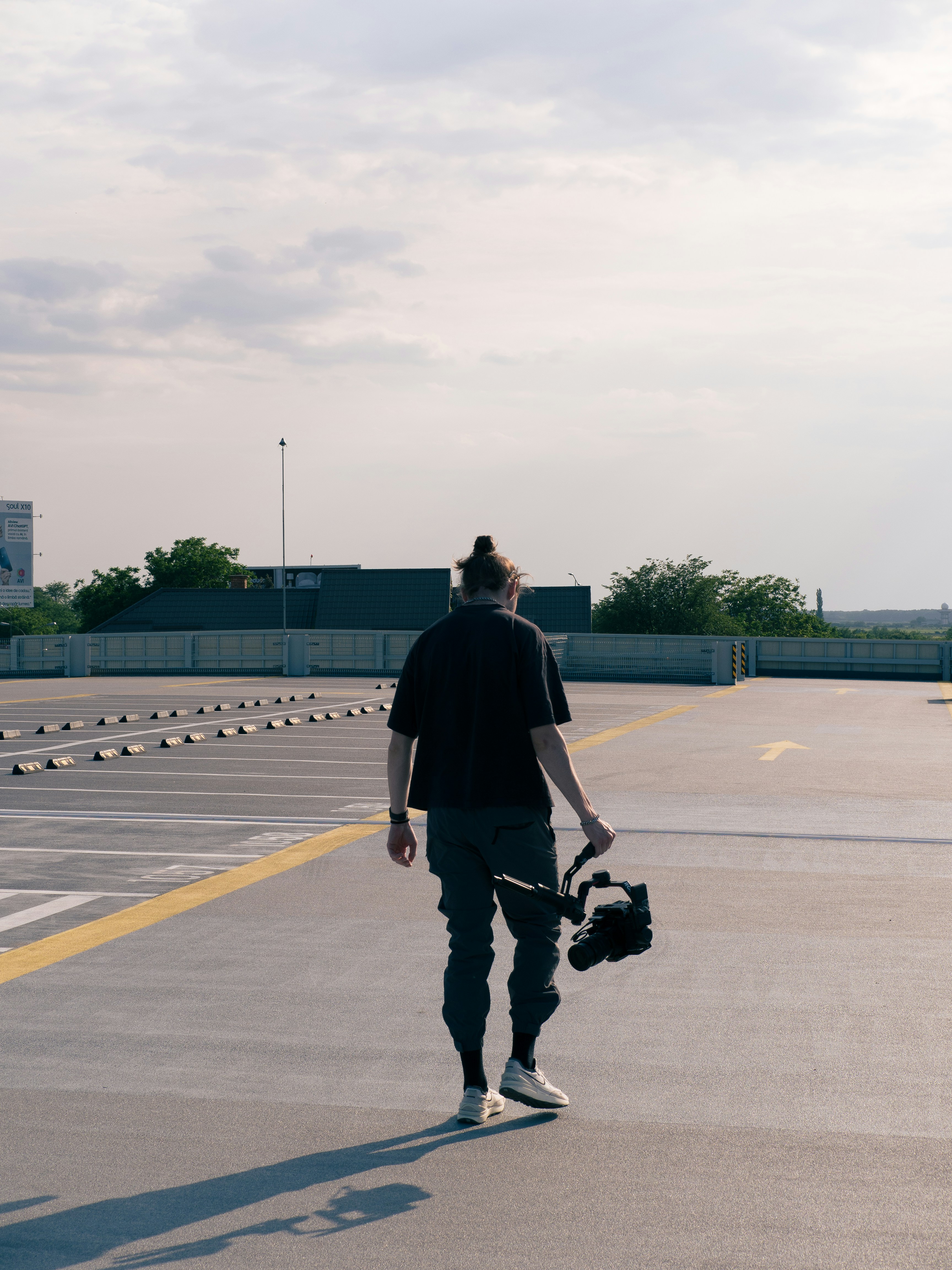 a man walking across an empty parking lot