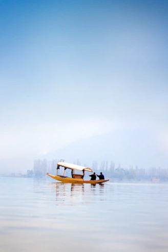 a small boat floating on top of a large body of water