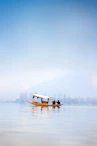 a small boat floating on top of a large body of water