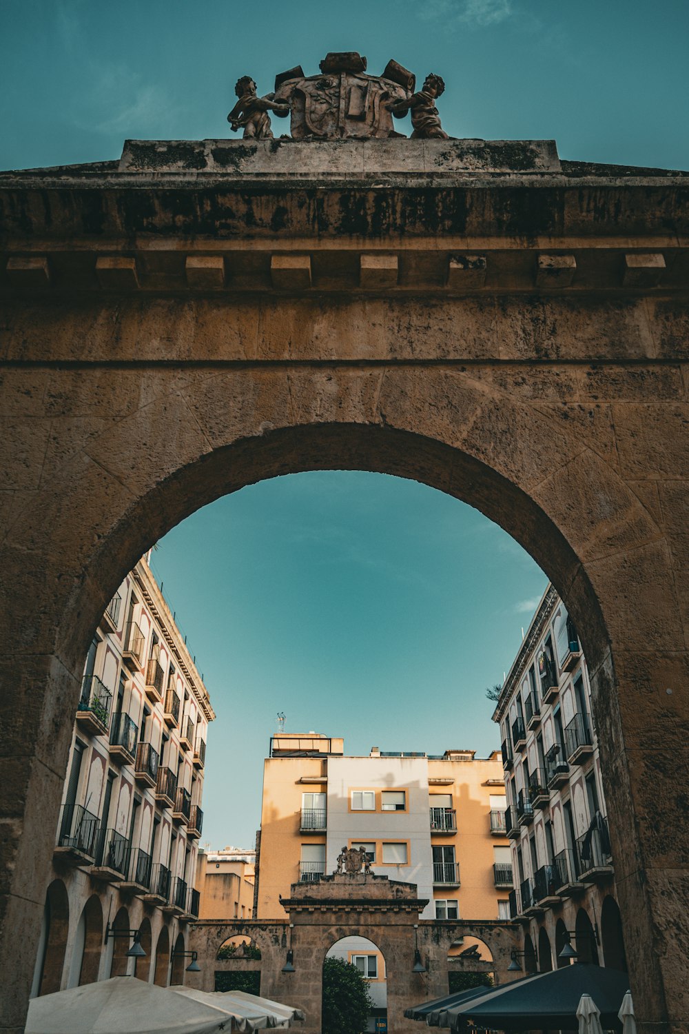 a stone arch with a clock on top of it