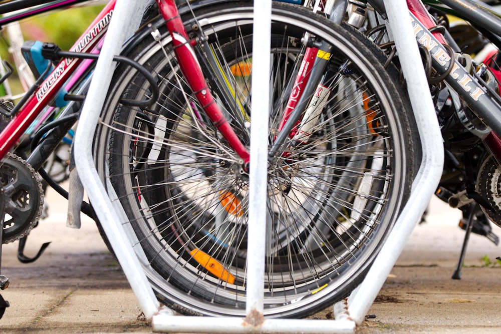 a close up of several bicycles parked on a sidewalk