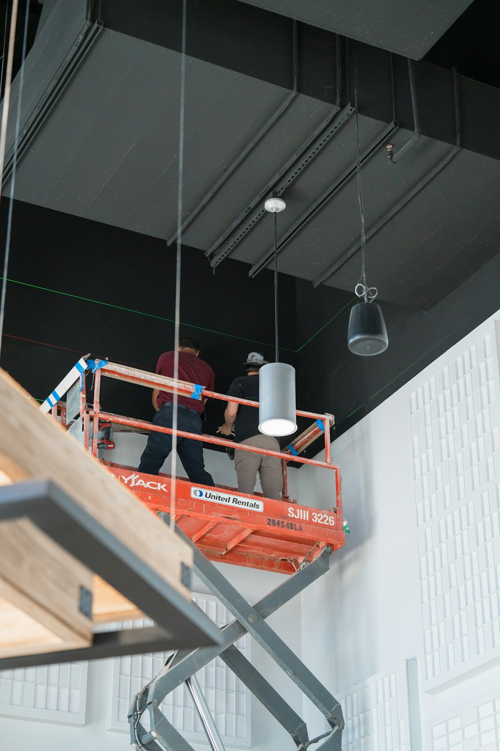 a couple of men standing on top of a lift