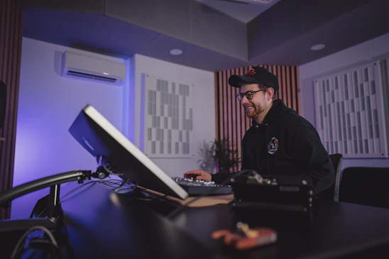 Soham working passionately in a modern creative studio filled with screens and camera equipment.