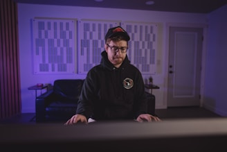 Corporate executive immersed in sensory deprivation training with blackout blindfold in a minimalistic room.