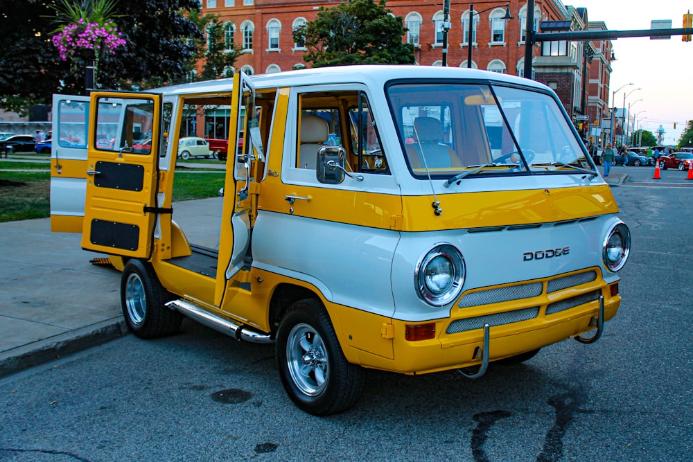 a small yellow and white truck parked on the side of the road