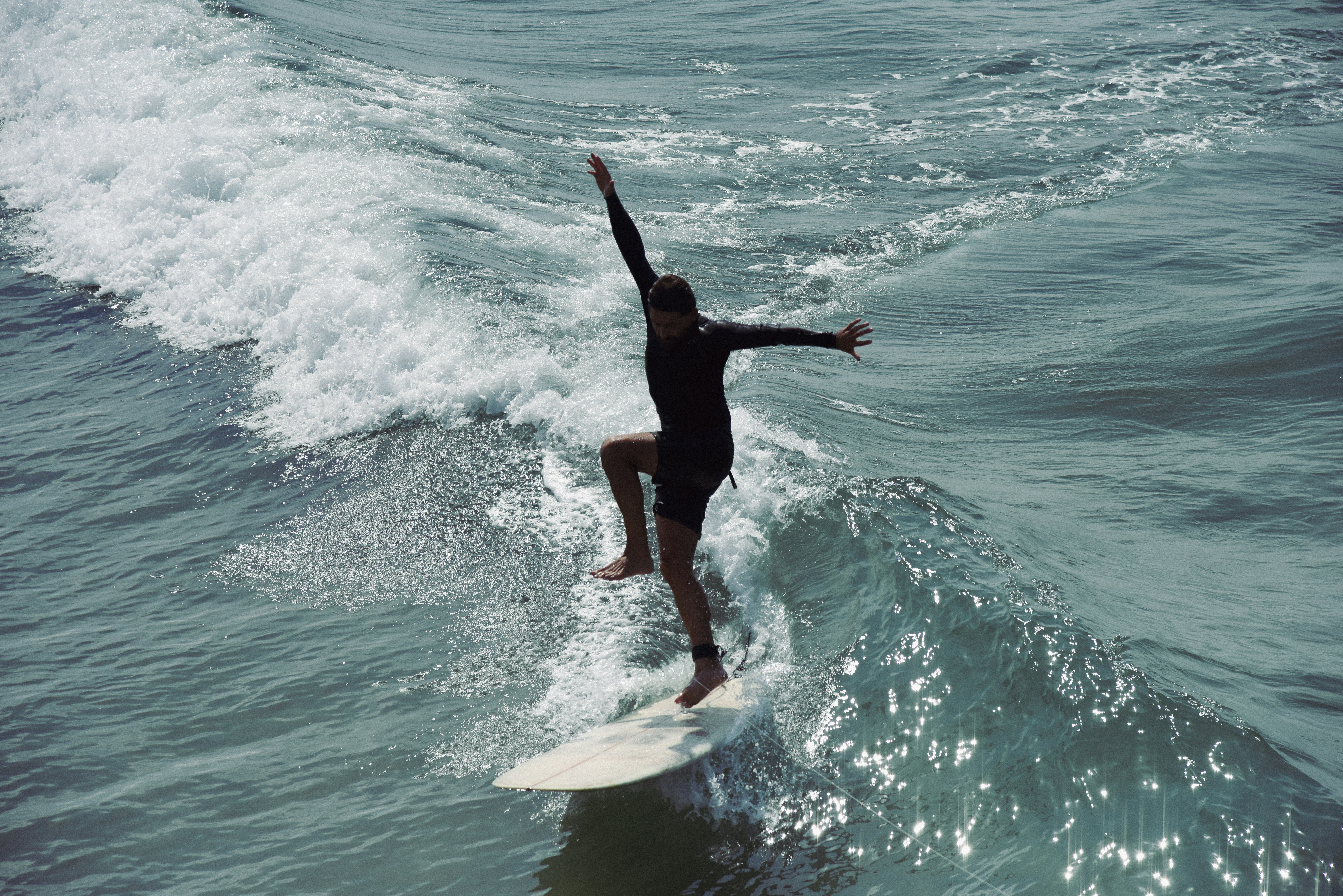 a person riding a surfboard on a wave in the ocean
