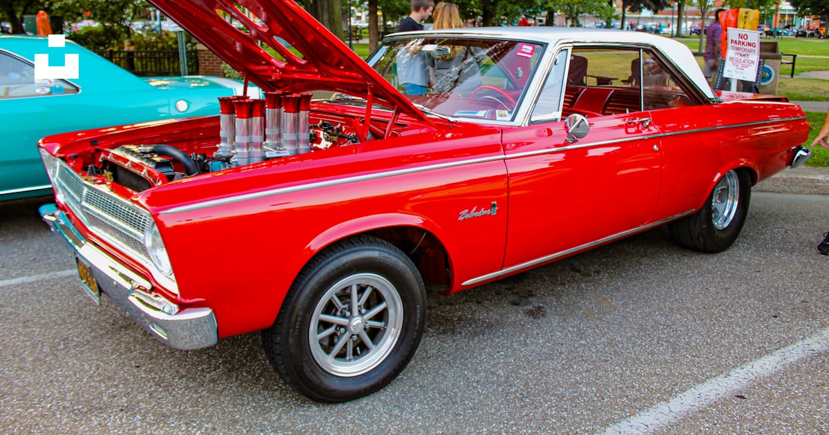 A red car with its hood open in a parking lot photo – Free Pa Image on ...