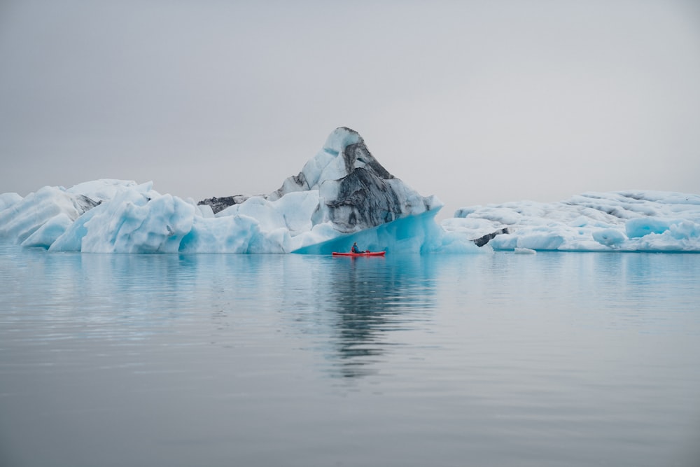 an iceberg in the middle of a body of water