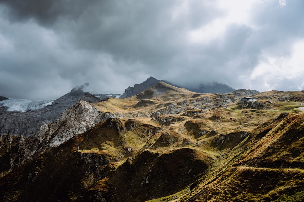 a mountain range with a cloudy sky in the background