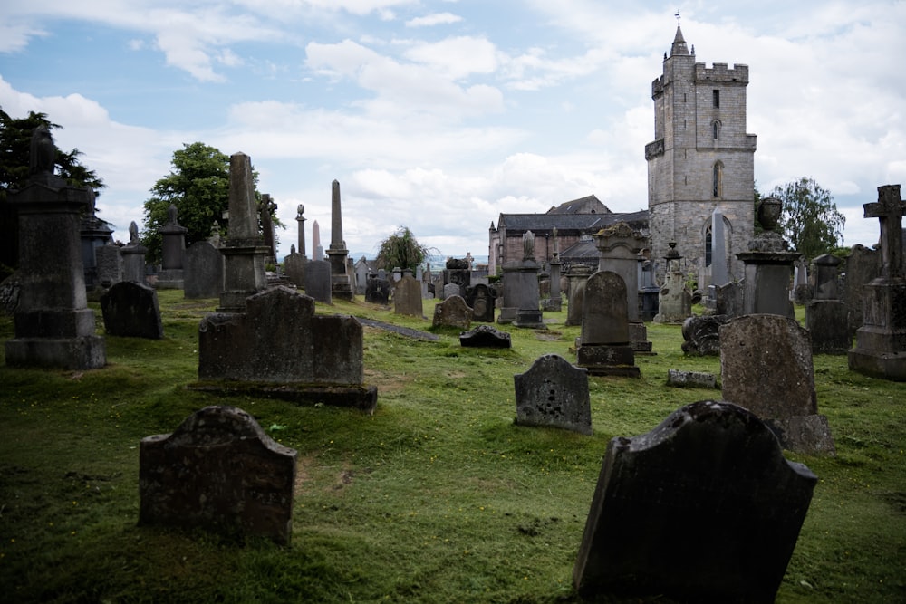 a cemetery with a tall tower in the background