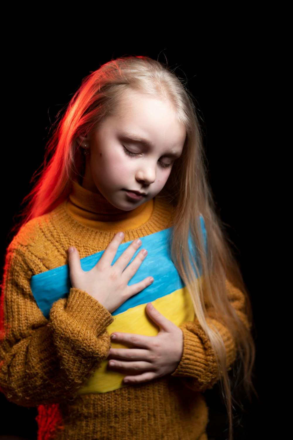a young girl holding a stuffed animal in her arms