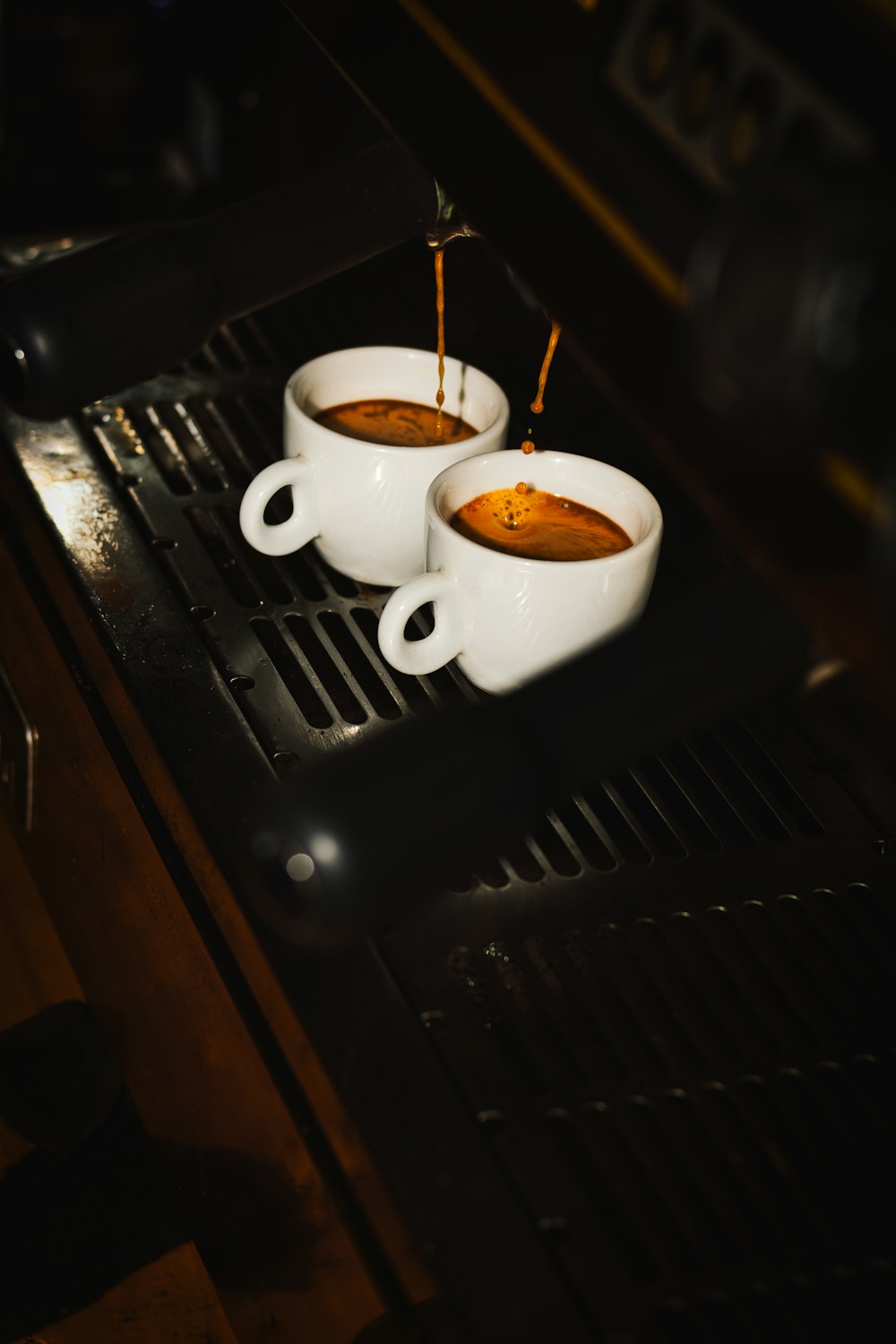 two cups of soup sitting on top of a stove