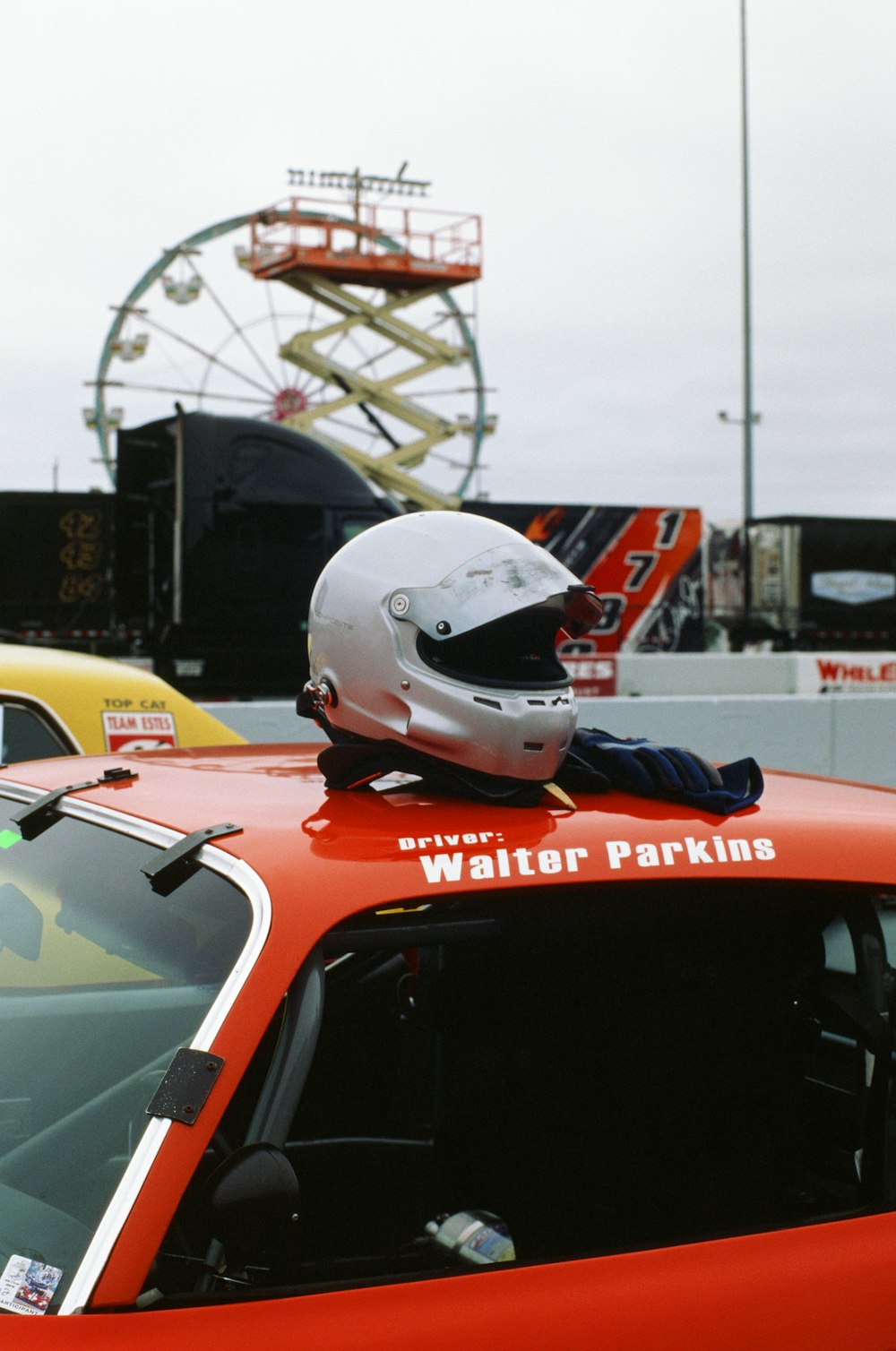 a red car with a helmet on top of it