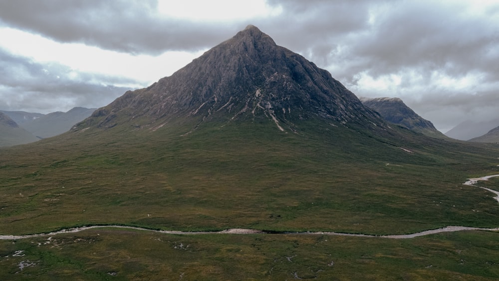 a large mountain with a river running through it