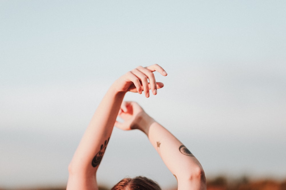 a woman with her arms up in the air