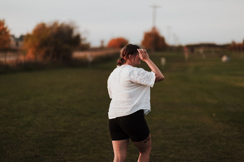 a person standing in a field with a frisbee
