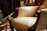 A beautifully restored vintage armchair with elegant upholstery in a cozy living room setting.