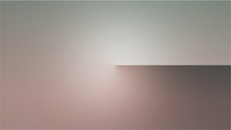 A minimalist scene featuring a gradient blending soft pastel colors like pink, gray, and beige. The composition includes a subtle division between the upper light area and the darker area below, creating a serene and abstract atmosphere.