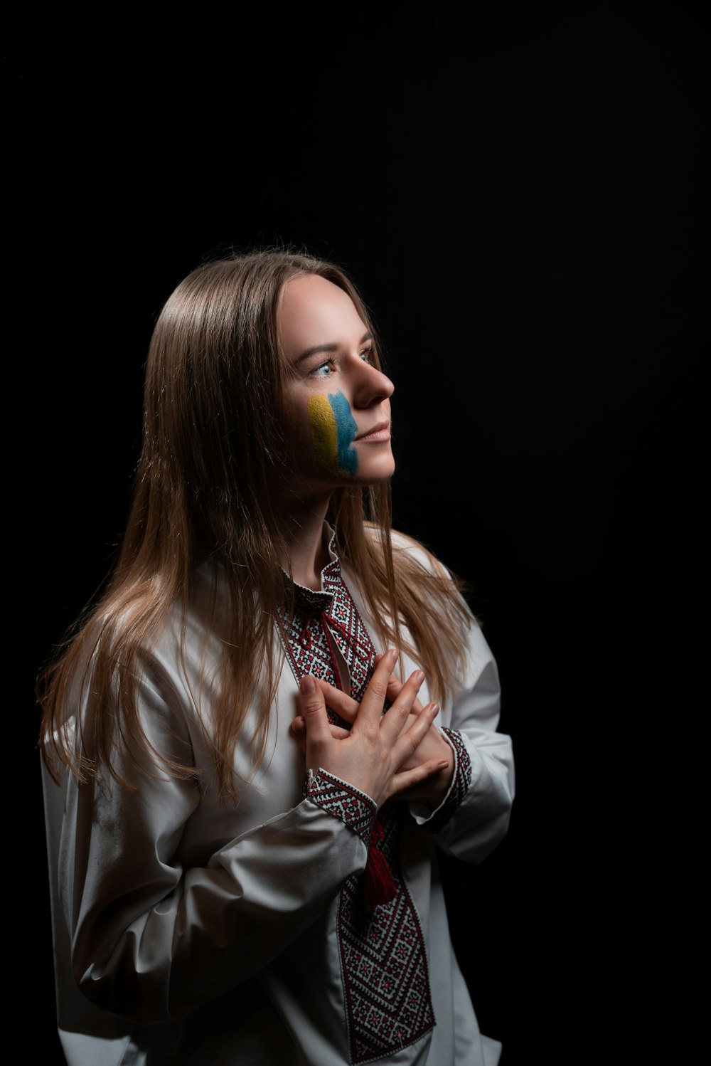 a woman with a tie and a painted face