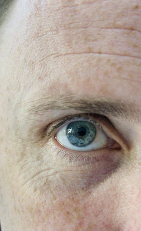 Close-up of a hyper-realistic skin painting showing intricate pores and subtle color variations.