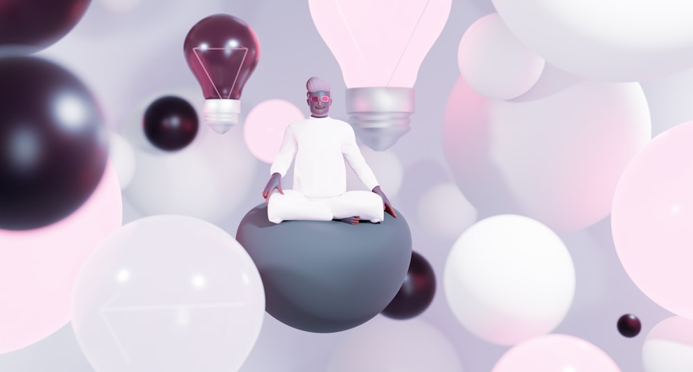 a person sitting on a ball surrounded by balloons