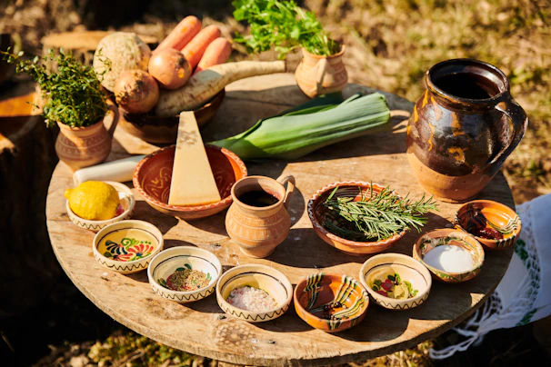 Close-up of a rustic wooden table set with fresh farm produce and artisanal dishes.